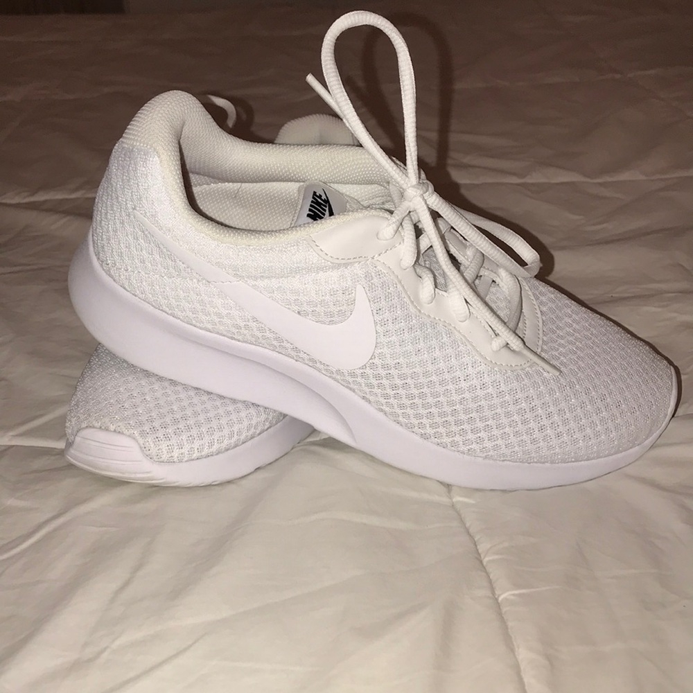 White Nike tennis shoes.